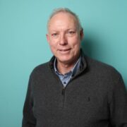 Man in grey sweater.