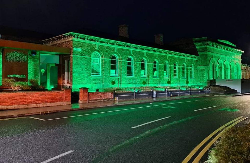 Building bathed in green light.