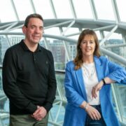 Man in black sweater and woman in blue jacket in Dublin.
