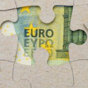Euro note behind a jigsaw puzzle.