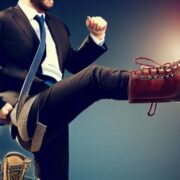 Businessman wearing giant red boots.
