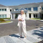 Woman standing in front of buildings.