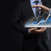 Business man in suit holding charts.