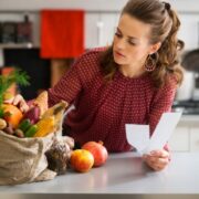 Woman inspecting grocery bag.