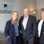 Two women and a man in an office.