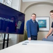 Two men in a boardroom.