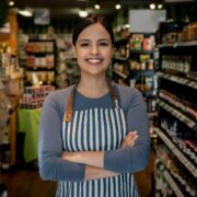 Female retail store owner smiling.