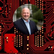 Man inset on image of digital circuit board.