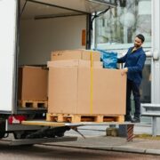 Man unloading IKEA boxes at a Tesco carpark.