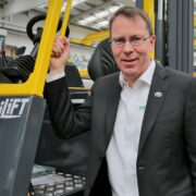 Man beside forklift.