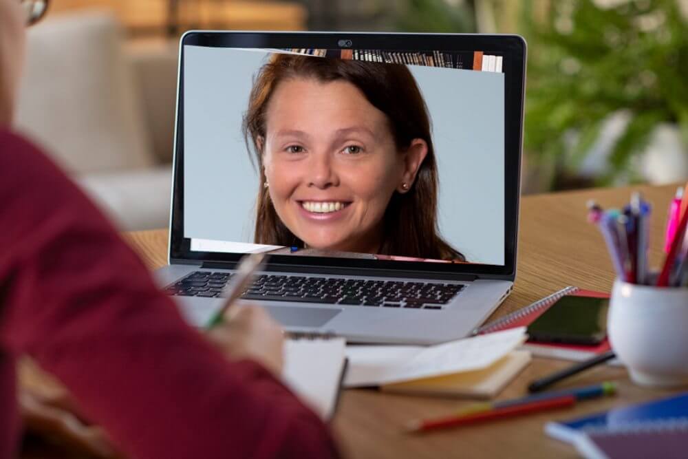 Smiling woman inset in image of a laptop computer.