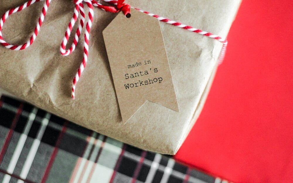 Christmas toy wrapped in brown paper with 'made in Sanda's workshop' on label.
