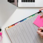 Person planning ahead using a diary and sticky notes.