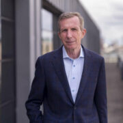 Man in navy suit jacket.