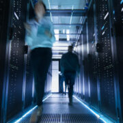Employees walking through a data centre.
