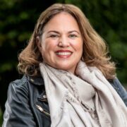 Brown-haired woman in leather jacket.