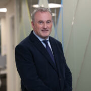 Businessman in dark suit in a corridor.
