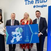 Two men and two women holding up a map of Ireland.