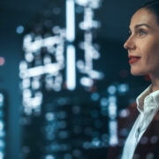 Woman CEO looking at cityscape.