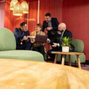 Three men and a woman discussing business.