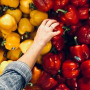 Woman selecting a fresh pepper.