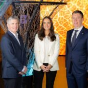 Two men and a woman in business attire.