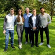 Four men and a woman in a park.