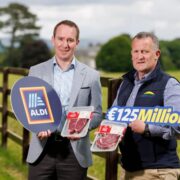 Two men standing in a field.