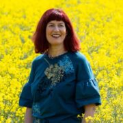 Woman in field of yellow flowers.