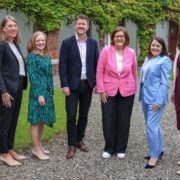 Five women and a man at a university.