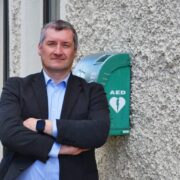 Man standing in front of public defibrillator.