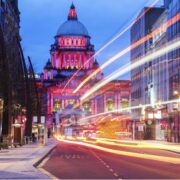 lights streak down a street in Belfast.