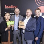 Four men and two women at an awards event.