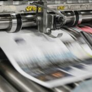 Newspapers rolling off the presses.