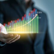 Man with virtual bar chart indicating rising sales.