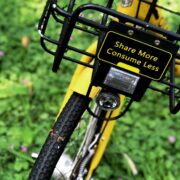 Bicycle with basket that says share more, consume less.