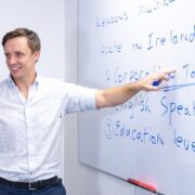 Male teacher in white shirt.