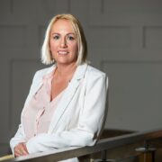 Woman in white jacket.