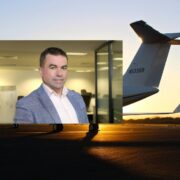 Man in suit inset on image of jet plane.