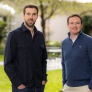 Two men in a garden.