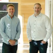 Founders of Wrksense standing in a sunny room.