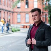 Man in dark sports jacket.