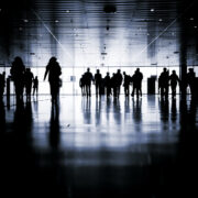 Large group of workers walking in a dark hall.