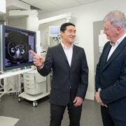Men in suits in a medical setting.