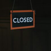 Closed sign on the door of a business.