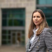 Woman wearing check jacket.