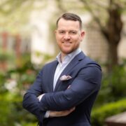 Man in navy sports jacket.