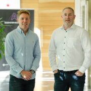 Two men wearing blue shirts.