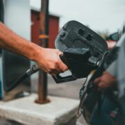 Man filling car with diesel at a fuel pump.