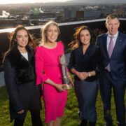 Three women and a man on a rooftop in Dublin.